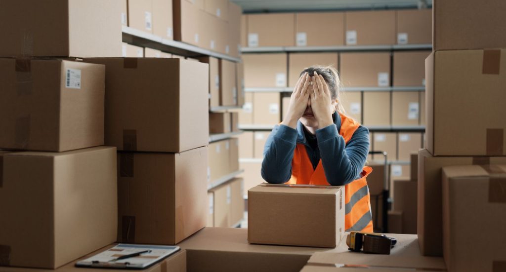 Mulher cansada e chateada porque está com estoque parado no seu negócio.