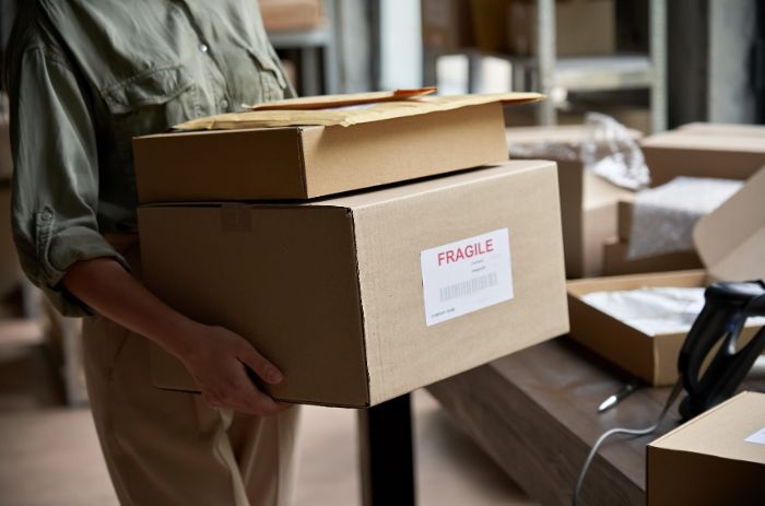 Mulher carregando encomendas após auxílio do fulfillment.